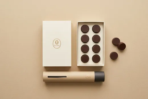 Flat lay of the sleeve, the open drawer with eight chocolates and the tube